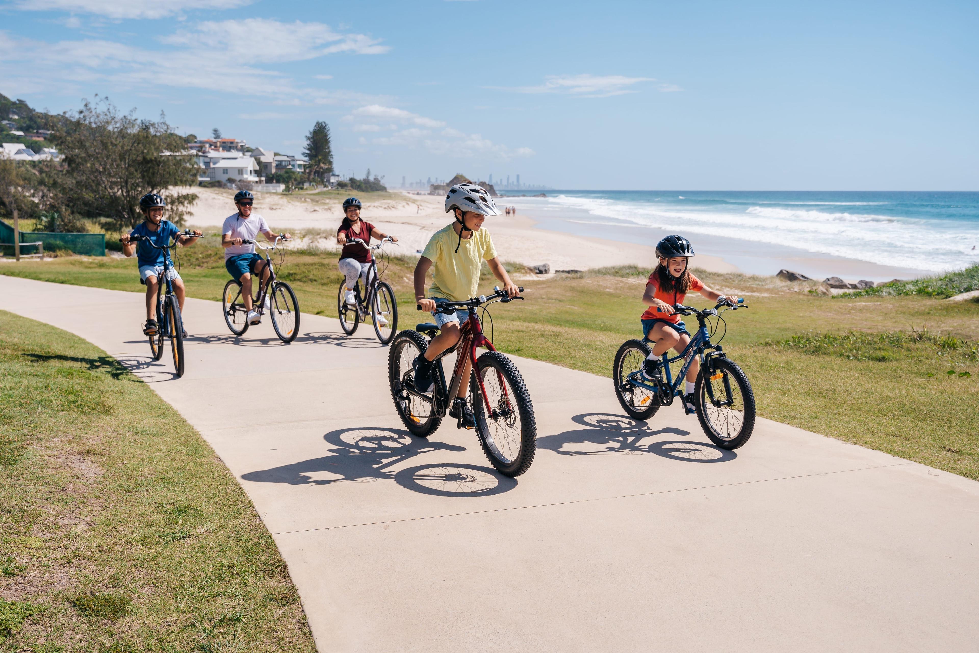 A family with kids riding bikes at Tugan Beach