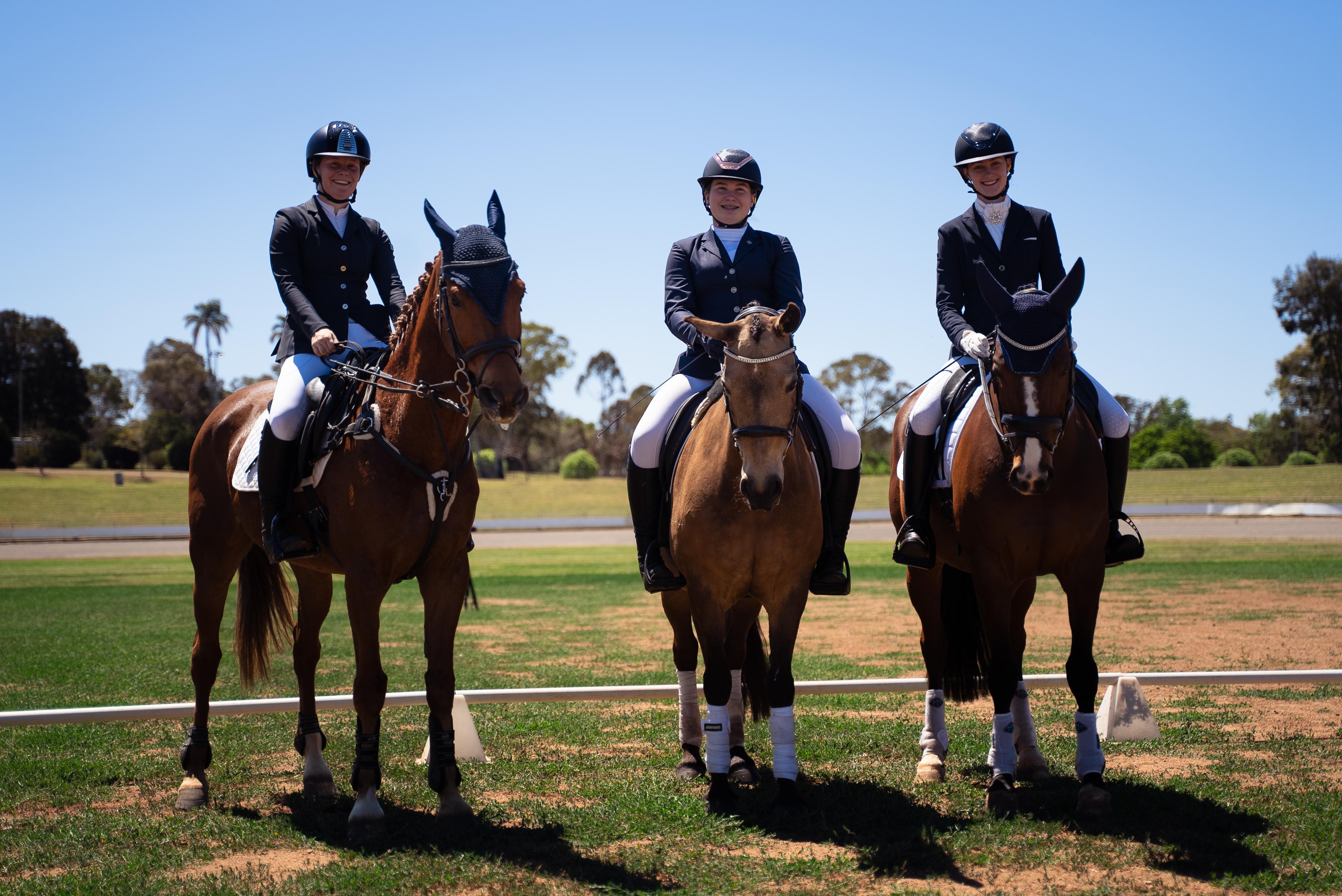Three equestrian athletes on horses at the Toowoomba Showgrounds